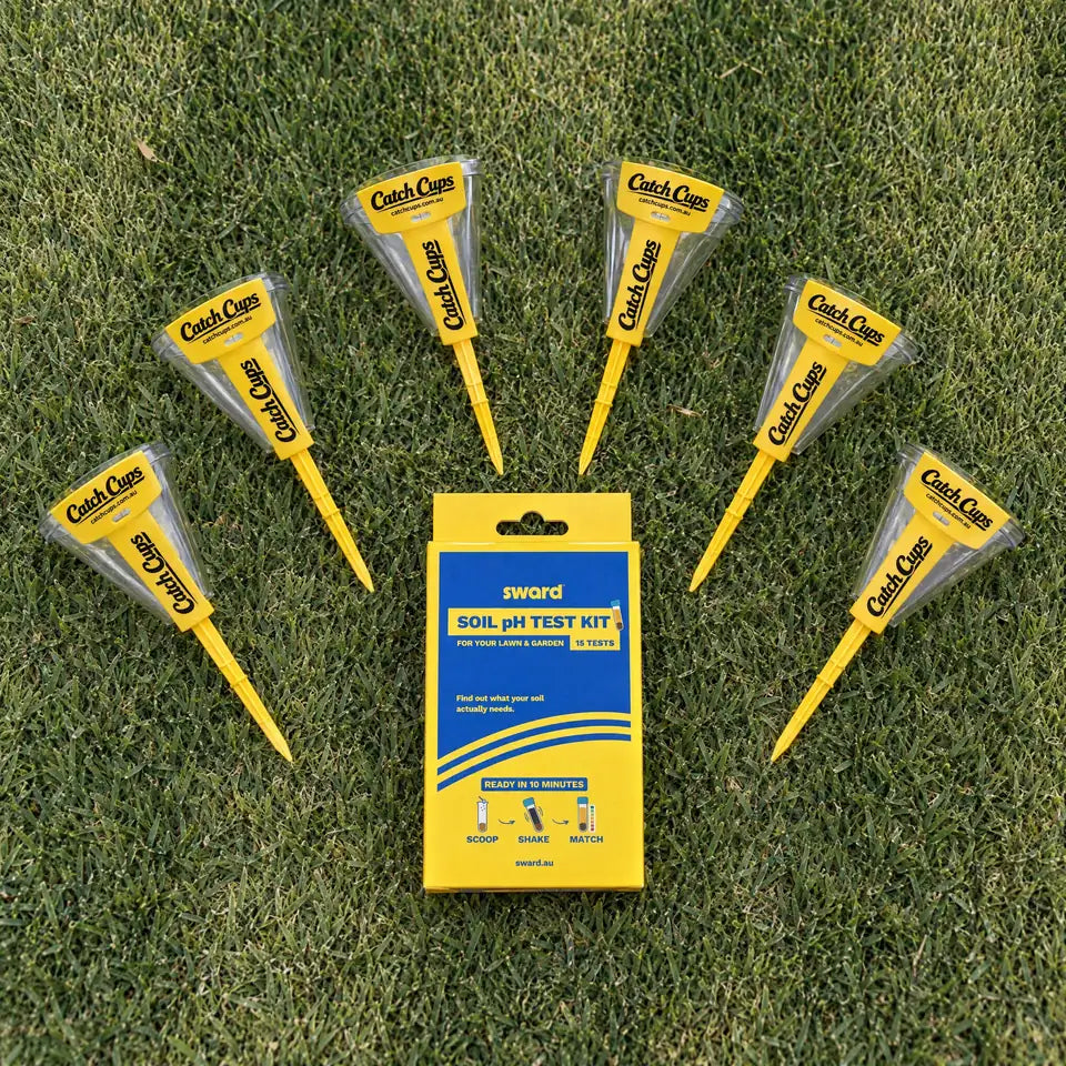 Catch Cups fanned around the Sward Soil pH Test Kit box on a lawn